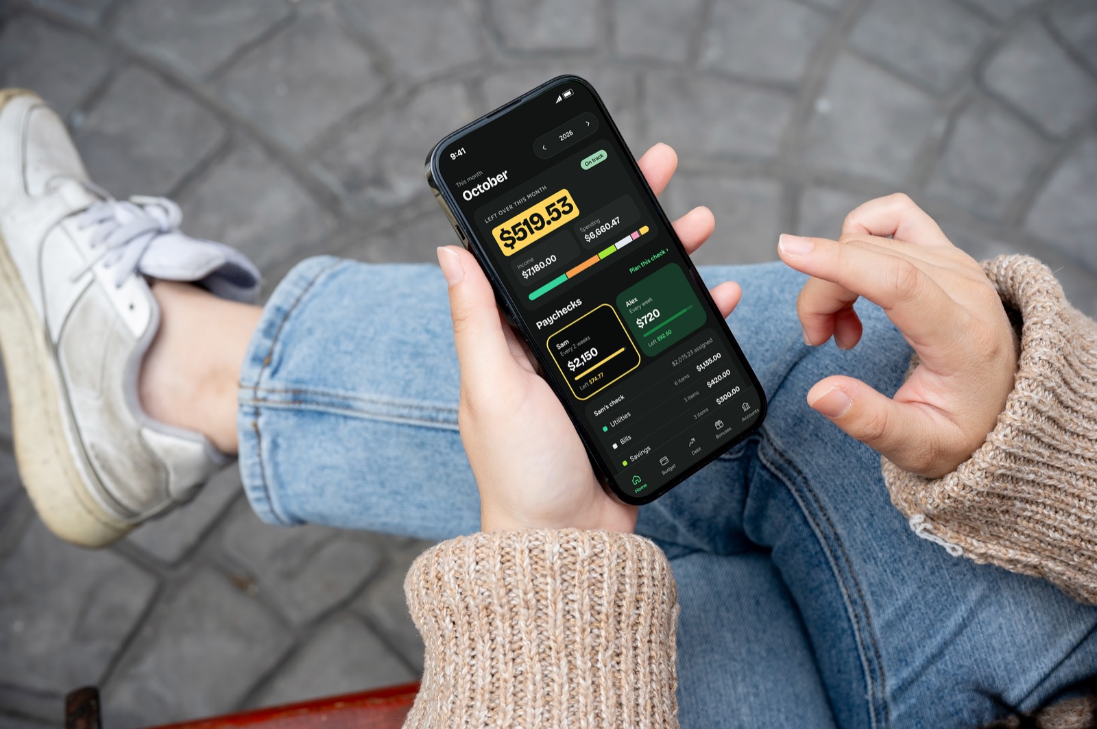 Someone holding a phone showing The Family Budget app